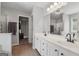Bright bathroom boasts a dual vanity sink, white cabinets, updated lighting, and a separate shower at 1535 Smoke Hill Dr, Hoschton, GA 30548