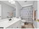 Clean, well-maintained bathroom with a vanity, mirror, and tiled shower at 1535 Smoke Hill Dr, Hoschton, GA 30548
