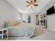 Spacious bedroom features tray ceilings, soft carpet, a queen bed, and a ceiling fan with modern shelving at 1535 Smoke Hill Dr, Hoschton, GA 30548