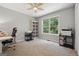 Bright bedroom with a large window and neutral colors, offering a serene and inviting space at 1535 Smoke Hill Dr, Hoschton, GA 30548