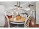 The dining area has a round wood table with chairs and a decorative light fixture, opening up to the living room at 1535 Smoke Hill Dr, Hoschton, GA 30548