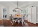 This dining area features a round table, four chairs, and modern light fixture near the window for natural lighting at 1535 Smoke Hill Dr, Hoschton, GA 30548
