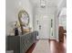 Entryway with a decorative cabinet, hardwood floors, and elegant lighting at 1535 Smoke Hill Dr, Hoschton, GA 30548