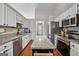Modern kitchen featuring granite countertops, stainless steel appliances, and a central island at 1535 Smoke Hill Dr, Hoschton, GA 30548