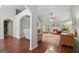 Cozy living room with hardwood flooring, a fireplace, and plenty of seating at 1535 Smoke Hill Dr, Hoschton, GA 30548