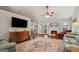 Spacious living room with hardwood floors, fireplace, and comfortable seating arrangement at 1535 Smoke Hill Dr, Hoschton, GA 30548