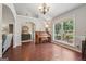Inviting living room with hardwood floors, piano, and natural light from a large window at 1535 Smoke Hill Dr, Hoschton, GA 30548