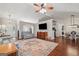 Open-concept living room with hardwood floors, TV, and stylish furnishings at 1535 Smoke Hill Dr, Hoschton, GA 30548