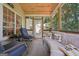 Relaxing screened porch with ample seating, pillows, and a view of the backyard at 1535 Smoke Hill Dr, Hoschton, GA 30548