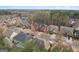 Aerial view of charming homes nestled in a quiet, tree-lined neighborhood, showcasing the community's appeal at 2126 Roberts View Trl, Buford, GA 30519