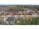An aerial view showcases beautiful homes in a well-maintained neighborhood with mature trees and landscaping at 2126 Roberts View Trl, Buford, GA 30519