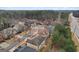 Aerial view of a diverse neighborhood with mature trees, winding streets, and well-kept homes at 2126 Roberts View Trl, Buford, GA 30519