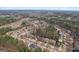A beautiful aerial view shows a neighborhood nestled in a lush forest, offering a serene residential setting at 2126 Roberts View Trl, Buford, GA 30519