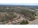 Aerial view of a desirable neighborhood featuring tree-lined streets, well-manicured lawns, and diverse home styles at 2126 Roberts View Trl, Buford, GA 30519