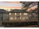 Exterior view of the back of the house showing a serene backyard and a covered patio at 2126 Roberts View Trl, Buford, GA 30519