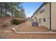 Backyard with a covered grill, patio, and brick retaining wall at 2126 Roberts View Trl, Buford, GA 30519