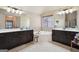 Bright bathroom featuring double vanity, soaking tub, and dual mirror lighting at 2126 Roberts View Trl, Buford, GA 30519