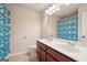 Bright bathroom with a double sink vanity, floral shower curtain, and neutral walls at 2126 Roberts View Trl, Buford, GA 30519