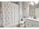 Bathroom with floral shower curtain, vanity, and decorative accents at 2126 Roberts View Trl, Buford, GA 30519