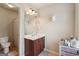 Bright bathroom featuring a vanity, unique decor, and a view into shower/toilet area at 2126 Roberts View Trl, Buford, GA 30519