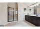 Bathroom featuring walk-in shower and vanity with dark wood cabinetry at 2126 Roberts View Trl, Buford, GA 30519