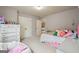 Bright bedroom with a large beanbag chair and a glimpse into an adjoining room at 2126 Roberts View Trl, Buford, GA 30519
