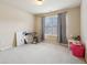 Bright bedroom featuring neutral walls, a window, and a music keyboard at 2126 Roberts View Trl, Buford, GA 30519