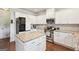 A kitchen with white cabinets, granite countertops, stainless steel appliances, and hardwood floors at 2126 Roberts View Trl, Buford, GA 30519