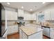 A kitchen with white cabinets, granite countertops, stainless steel appliances, and hardwood floors at 2126 Roberts View Trl, Buford, GA 30519