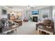 Bright living room featuring a fireplace, large windows, and an open view of the kitchen at 2126 Roberts View Trl, Buford, GA 30519