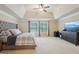 The main bedroom features tray ceilings, a ceiling fan, and a flat screen tv at 2126 Roberts View Trl, Buford, GA 30519