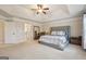 Spacious main bedroom features tray ceilings, and neutral decor at 2126 Roberts View Trl, Buford, GA 30519