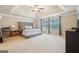 The main bedroom features tray ceilings, a ceiling fan, and bright windows at 2126 Roberts View Trl, Buford, GA 30519