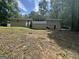 Large backyard with mature trees, a screened porch and deck at 4329 Parkview Dr, Lithia Springs, GA 30122