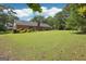 Large, well-maintained backyard featuring a brick home, lush lawn, and mature shade trees at 109 Old Virginia Cir, Jonesboro, GA 30236