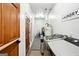 Well-organized laundry room with modern washer/dryer, ample storage, and a utility sink at 109 Old Virginia Cir, Jonesboro, GA 30236