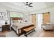 Spacious main bedroom with tray ceilings, a sliding door, and a seating area at 109 Old Virginia Cir, Jonesboro, GA 30236