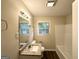 Updated bathroom with a granite vanity, a large mirror, and a shower-tub combination at 70 Macon Se Pl, Atlanta, GA 30354