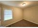 Bedroom featuring a window, neutral walls, and cozy carpet for a peaceful retreat at 70 Macon Se Pl, Atlanta, GA 30354