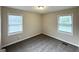 Bright bedroom with two windows and neutral carpet, providing a clean and spacious atmosphere at 70 Macon Se Pl, Atlanta, GA 30354