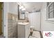 Modern bathroom with a white vanity, wood-look flooring, and a shower behind a white curtain at 2101 Newgate, Decatur, GA 30035