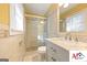 Well-lit bathroom with tiled shower, marble vanity, and modern fixtures at 2101 Newgate, Decatur, GA 30035