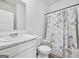 A clean bathroom features a white vanity with cultured marble top and a shower with Parisian-themed curtain at 469 Ralph Still, Dacula, GA 30019