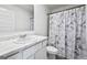 Bathroom with white cabinet and patterned shower curtain at 469 Ralph Still, Dacula, GA 30019