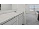 Bright bathroom vanity with white cabinets, marble countertop and view to bedroom at 469 Ralph Still, Dacula, GA 30019