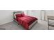 Cozy bedroom with soft gray carpet and a comfortable bed dressed in red linens at 469 Ralph Still, Dacula, GA 30019