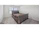 Bedroom with bright natural light, carpet floors, and a patterned bed at 469 Ralph Still, Dacula, GA 30019