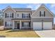 Charming two-story home with a well-maintained lawn, featuring a gray facade and attached two-car garage at 469 Ralph Still, Dacula, GA 30019
