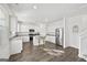A bright kitchen features white cabinets, stainless steel appliances, a granite countertop, and a spacious island at 469 Ralph Still, Dacula, GA 30019