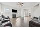 Spacious living room with hardwood floors, comfortable leather sofas, fireplace, and plenty of natural light at 469 Ralph Still, Dacula, GA 30019
